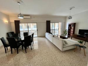 ein Wohnzimmer mit einem Sofa und einem Esszimmer in der Unterkunft Seaview 3 bedroom apartment in Sliema in Sliema