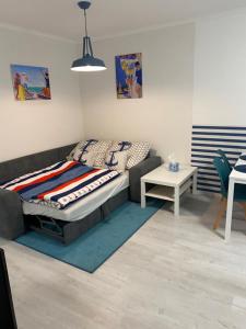 a living room with a bed and a couch at City Center Apartman 2. Nagykanizsa in Nagykanizsa