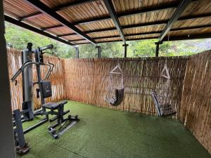 a gym with a wall with a treadmill and weights at Panorama Guest House in Johannesburg