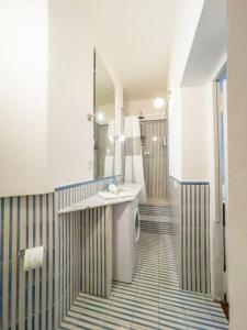 a bathroom with a toilet and a sink and a mirror at [Trevi] Domus Avignonesi in Rome +15 photos