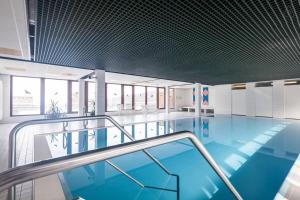 a swimming pool with blue water in a building at Terrassenpark Apartments (low budget) in Sasbachwalden