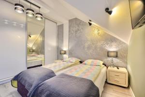 Posteľ alebo postele v izbe v ubytovaní Art Apartament Krynica Zdrój Centrum