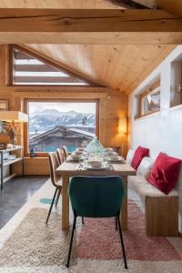 a dining room with a table and a couch at Luxurious Chalet in Verbier in Verbier