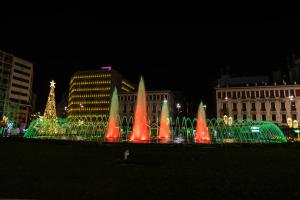 a water fountain in front of a city at night at Evita Asty in Athens