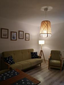 a living room with a couch and a lamp at Apartament śródmiejski in Gdańsk