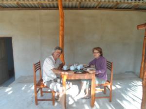 a man and woman sitting at a table at Sunshadow Chalet in Tangalle +69 photos