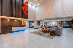 a lobby of a hotel with a couch and a table at Wingate by Wyndham - DFW North in Irving