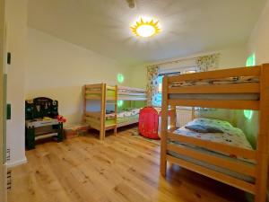 two bunk beds in a room with wooden floors at Ferienhaus Hinrichs 