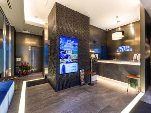a lobby with a large screen in a building at HOTEL LiVEMAX Akasaka in Tokyo