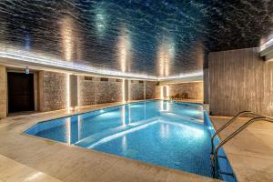 a large swimming pool in a building with a ceiling at Centrally Located Flat with Balcony in Beyoglu in Istanbul