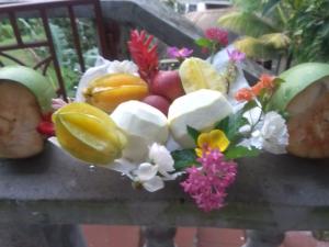 a bouquet of fruits and vegetables on a table at Zaboca apartment in Roseau