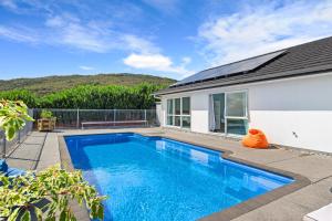 a swimming pool in the backyard of a house at Green View - Parua Bay Holiday Home in Parua Bay