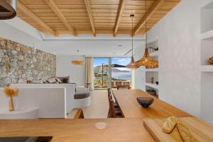 a living room with a table and a couch at Villa Eureka BY APOKORONAS-VILLAS in Plaka