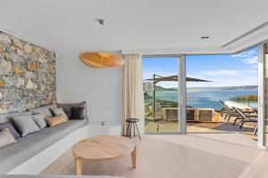 a living room with a couch and a table at Villa Eureka BY APOKORONAS-VILLAS in Plaka