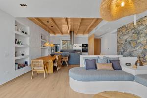 a living room with a couch and a dining room at Villa Eureka BY APOKORONAS-VILLAS in Plaka