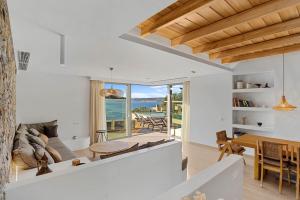 a living room with a view of the ocean at Villa Eureka BY APOKORONAS-VILLAS in Plaka