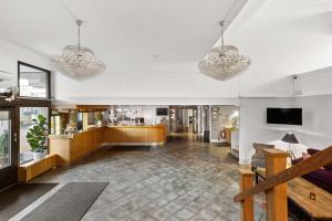 a lobby with several chandeliers hanging from the ceiling at Best Western Hotel Statt Katrineholm in Katrineholm