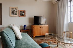 a living room with a couch and a tv at Into the Mystic in Paternoster