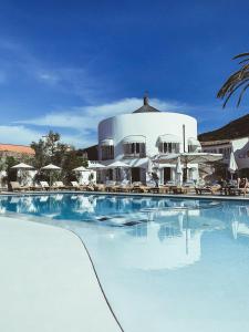 a large swimming pool in front of a building at Le Calette Bay in Cefalù