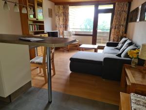 a living room with a couch and a table at BFE Schwarzwaldidylle in Baiersbronn