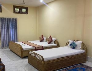 Zimmer mit 2 Betten in einem Zimmer in der Unterkunft TG Resort in Nāmdāng
