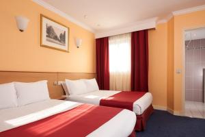 Letto o letti in una camera di Grand Hôtel Amelot