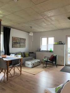 a living room with a couch and a table at Landhof Lieg - Ferienwohnungen in Lieg