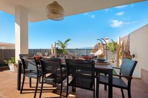 une salle à manger avec une table et des chaises sur une terrasse dans l'établissement Villa View Candesol, à Santiago del Teide