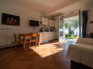 a kitchen and living room with a table and a table and chairs at Tra Gli Ulivi in Pietra Ligure