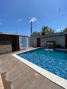 a swimming pool in the backyard of a house at Beach House Sao Jose in São José da Coroa Grande