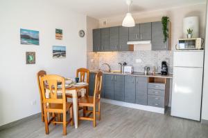 a kitchen and dining room with a table and chairs at New & Renovated Vacation Apartment in Costa de Antigua