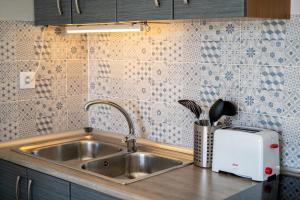 a kitchen counter with a sink and a toaster at New & Renovated Vacation Apartment in Costa de Antigua