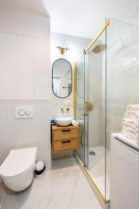 a bathroom with a toilet and a sink and a shower at Żoliborz Elite Apartment in Warsaw