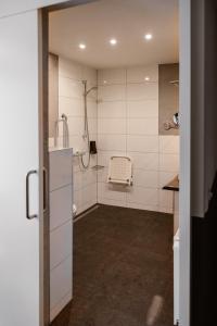 a bathroom with a shower and a sink at Hotel Torpedoloods in Hoek van Holland