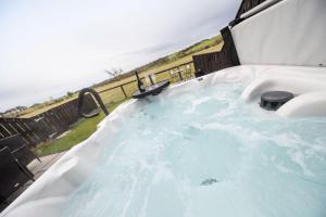 a jacuzzi tub with a view of the ocean at The Tiny Chapel in Hexham