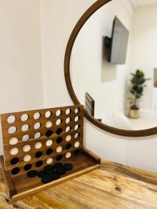 a mirror sitting on top of a table with a board at St Duthus Villa Guesthouse in Tain