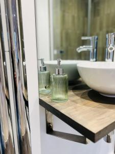 a bathroom with a sink and a mirror at St Duthus Villa Guesthouse in Tain