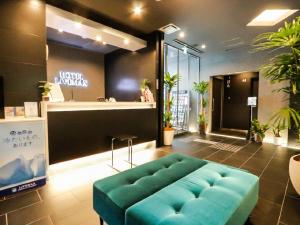a store with a blue couch in a lobby at HOTEL LiVEMAX Takadanobaba Ekimae in Tokyo