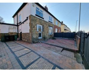 an old brick house with a fence in front of it at Luxury double bed with Private Bathroom, NETFLIX, work space and WiFi in Leeds