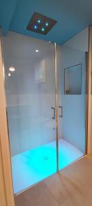 a room with a glass wall with blue lights at B&B Giro Di Boa in Lampedusa