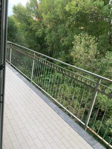 a walkway with a metal fence and trees at Mood-San Matteo Residence Parva Urbi in Pavia