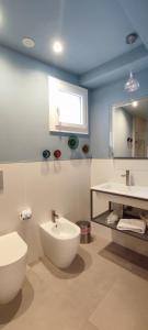 a bathroom with a sink and a toilet and a mirror at B&B Giro Di Boa in Lampedusa