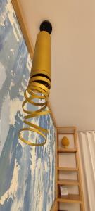 a gold light hanging from the ceiling of a room at B&B Giro Di Boa in Lampedusa