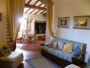 a living room with a couch and a dining room at Due Piani in Barberino di Val dʼElsa