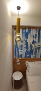 a bedroom with a bed and a table and a lamp at B&B Giro Di Boa in Lampedusa
