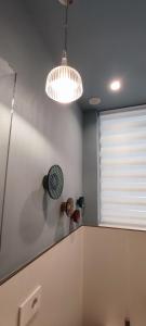 a kitchen with two lights and a white wall at B&B Giro Di Boa in Lampedusa