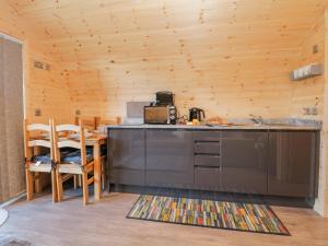 a kitchen with a counter and a table with chairs at Cherry in Ulverston +18 photos