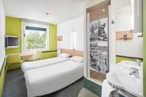 Postel nebo postele na pokoji v ubytování ibis budget Wrocław Południe