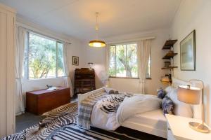 a zebra themed bedroom with a bed and windows at Naos Farm Stay 