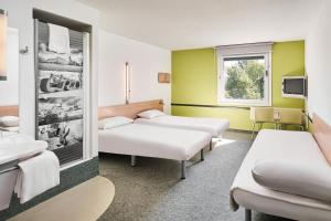 Postel nebo postele na pokoji v ubytování ibis budget Wrocław Południe